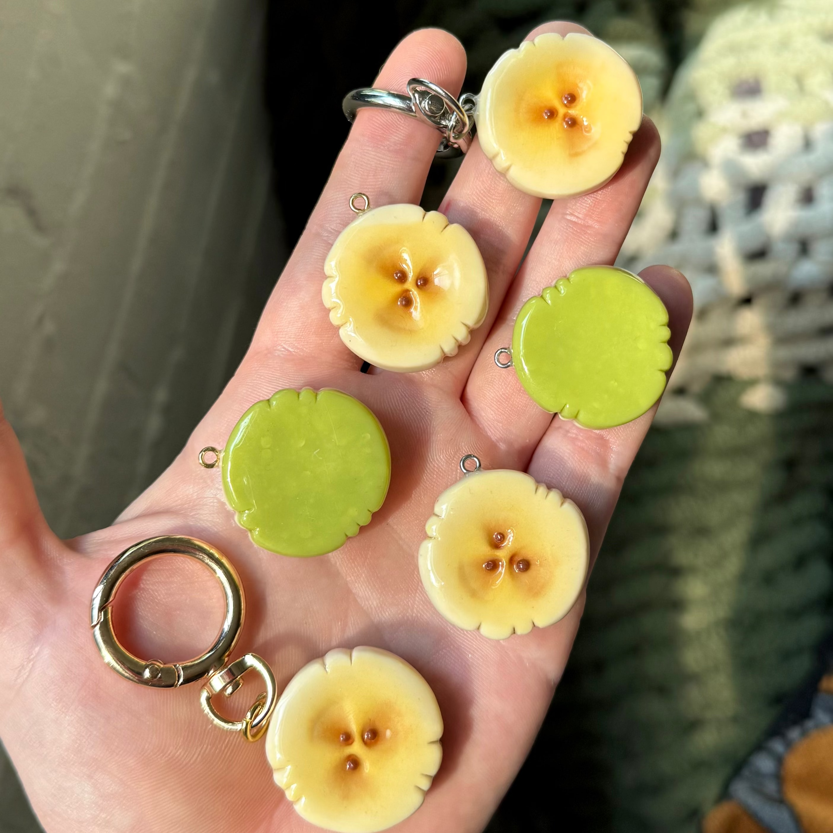 Banana slice keychains with green back sides. 