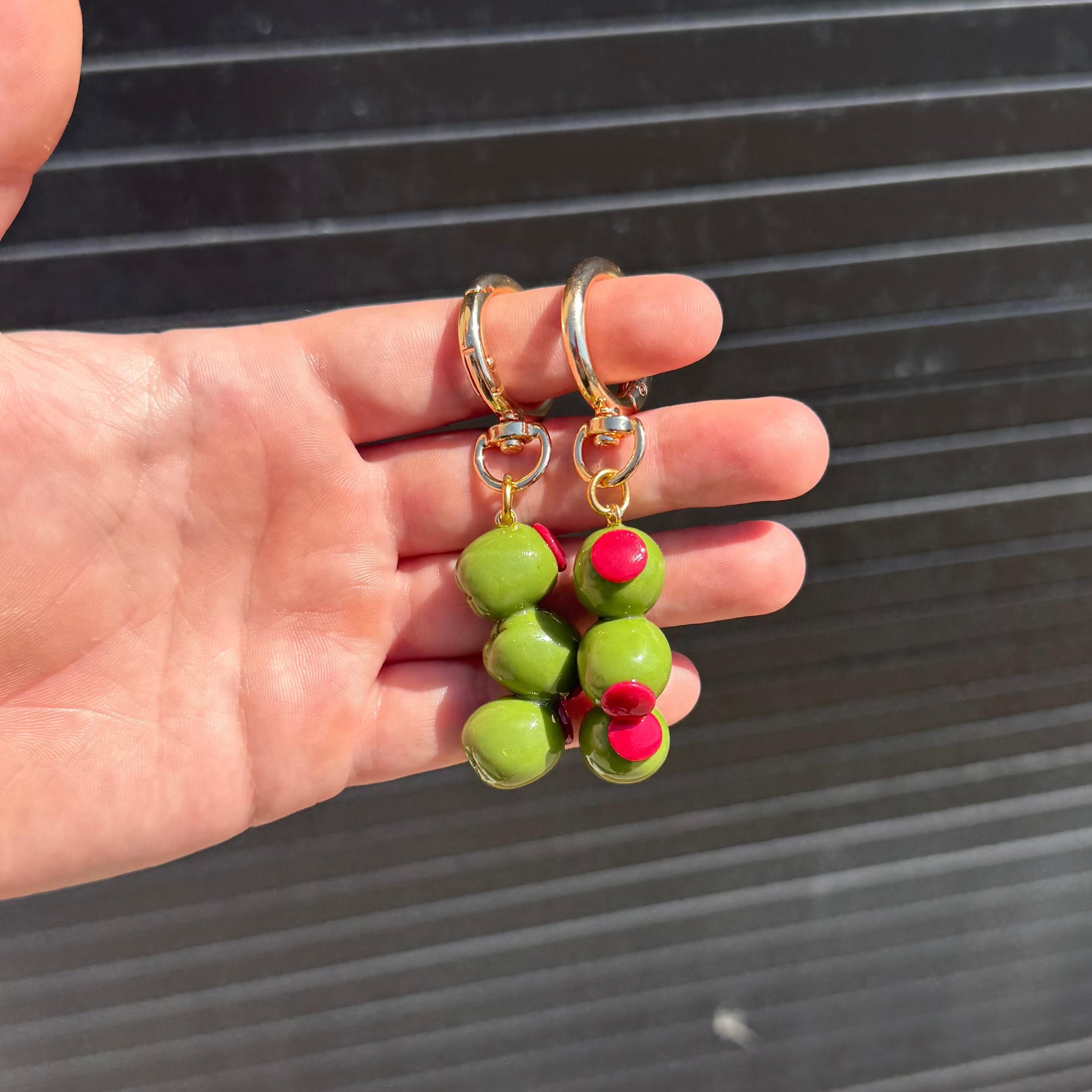 two keychains with 3 stacked olive charm hanging. 